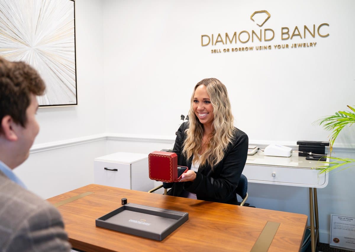 A Diamond Banc expert showing a jewelry box to a client during an in-office consultation